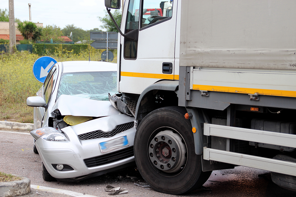 A car in an accident with a semi-truck.